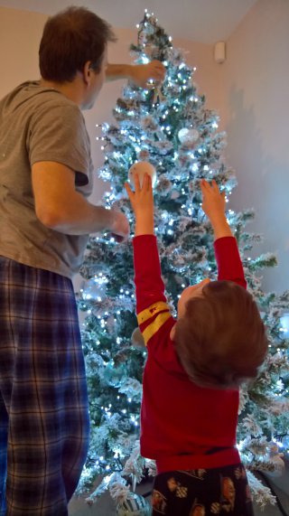 Ethan_and_i_reaching_putting_up_the_christmas_tree_dec_2018