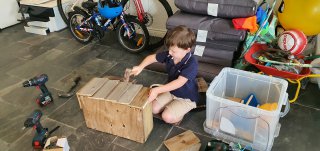 Ethan_hammering_recycled_wood_plant_box_aug_2020