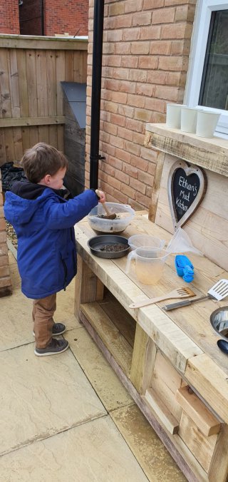 Ethan_playing_building_mud_kitchen_part_2_may_2020