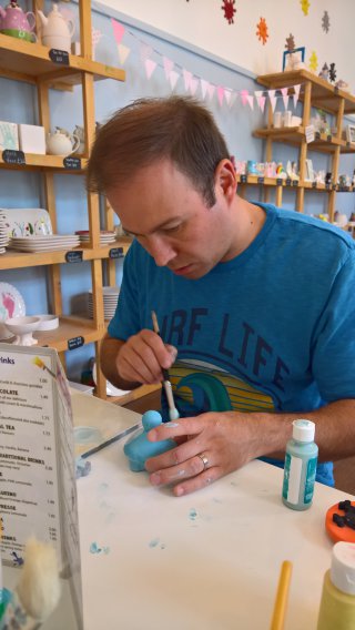 Me_concentrating_pottery_painting_august_2019