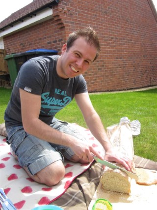 Me_cutting_bread_picnic_day_may_2013